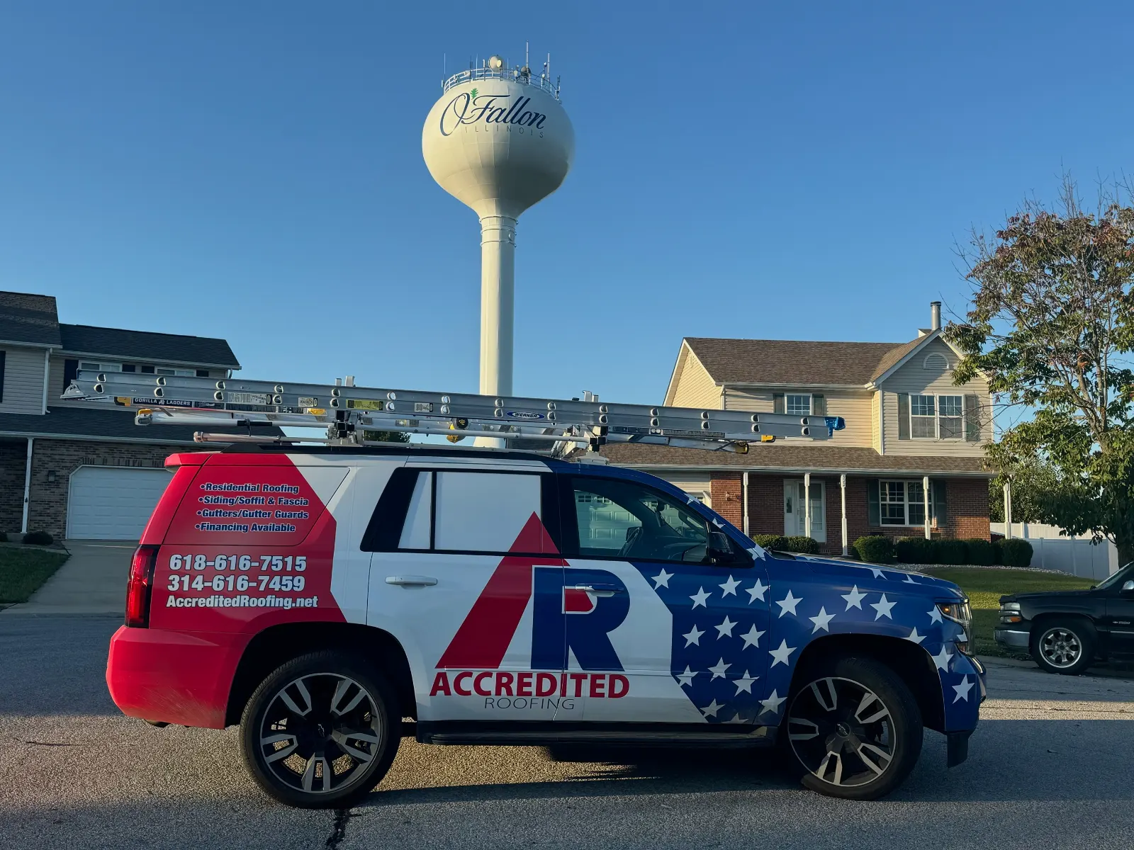 O'Fallon water tower behind Accredited Roofing service truck